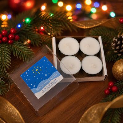 Peace on Earth soy tea lights with Pine and Spruce oils, glowing softly among winter greenery.