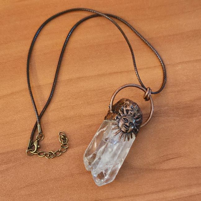 Twin clear quartz crystal pendant set in copper with sun charm, symbolizing Twin Flames and soulmates.