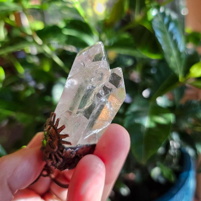 Twin clear quartz crystal pendant set in copper with sun charm, symbolizing Twin Flames and soulmates.