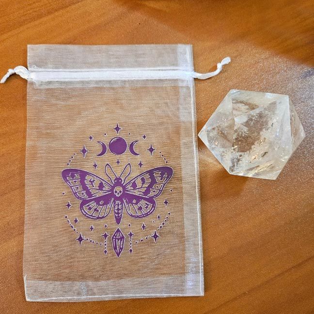 White organza bag with violet moth, moon phases, and crystal printed design.