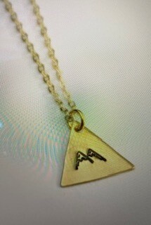 Jewelry/snow caps on mountain/gold