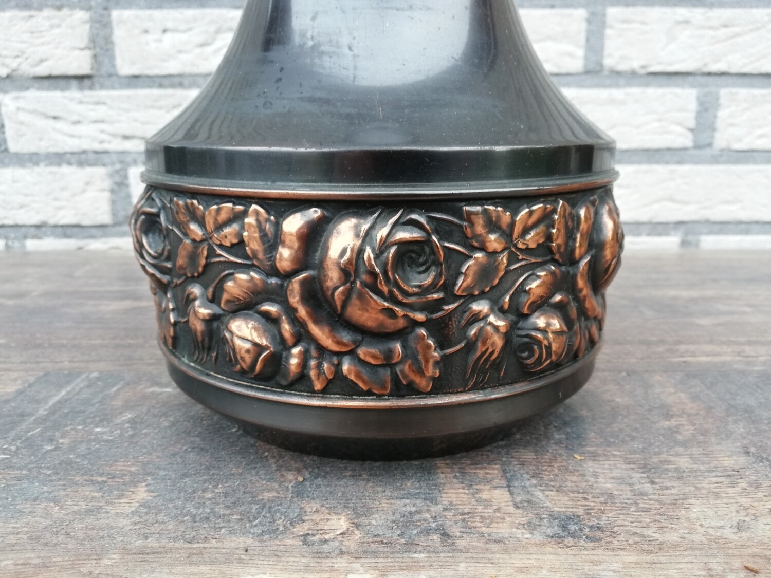 Old copper vase with floral relief