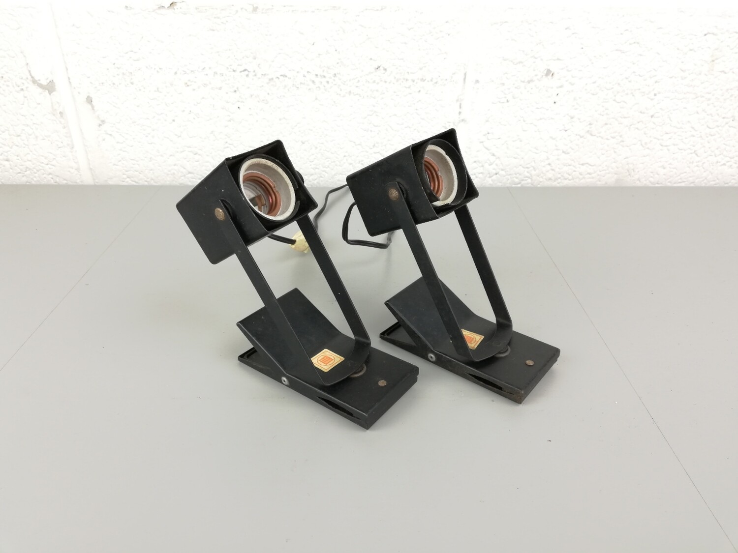 2 black Lita clamp lamps