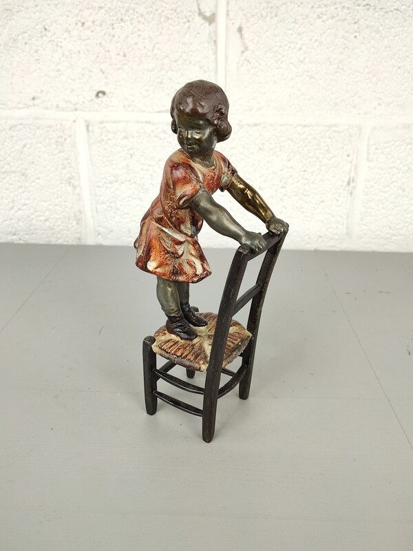Sculpture of a girl on a chair