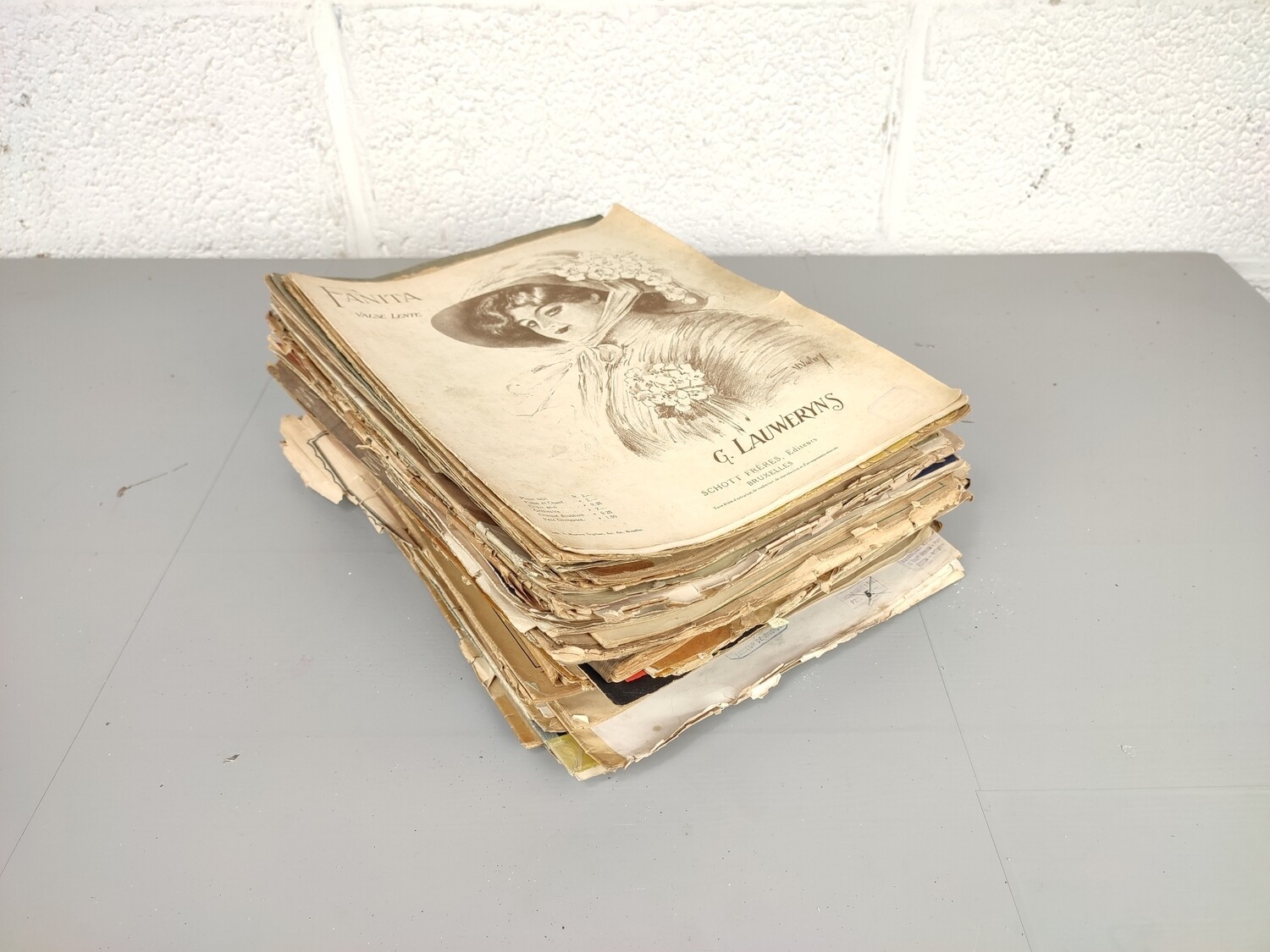 Large pile of piano sheet music