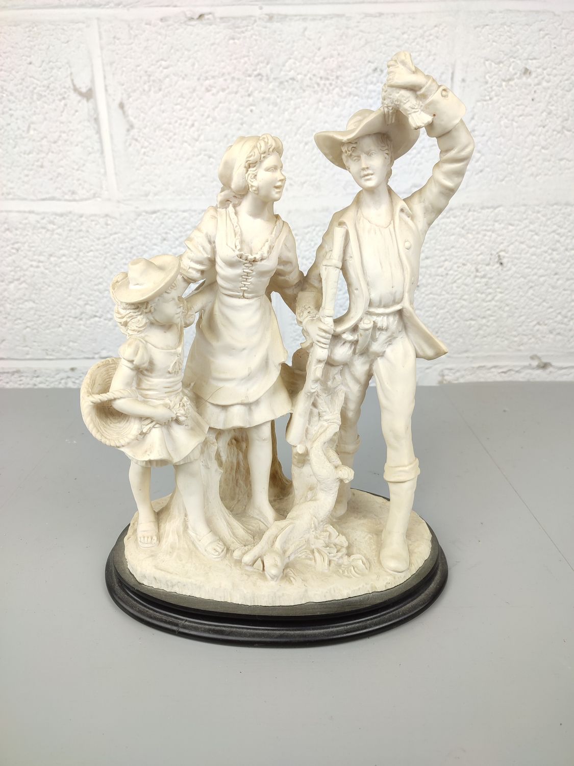 Statue in resin of a hunter with family