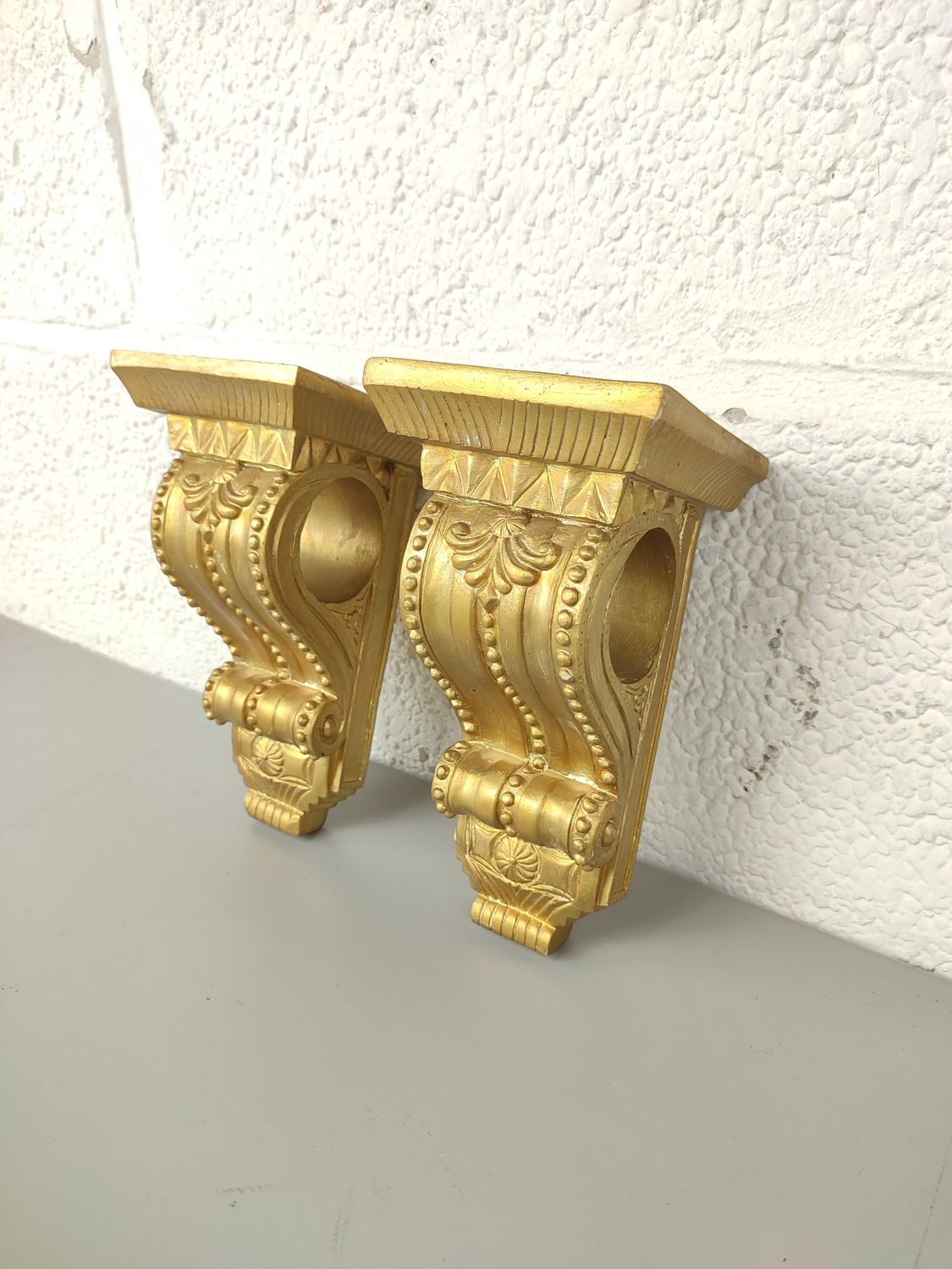 2 small gilded consoles