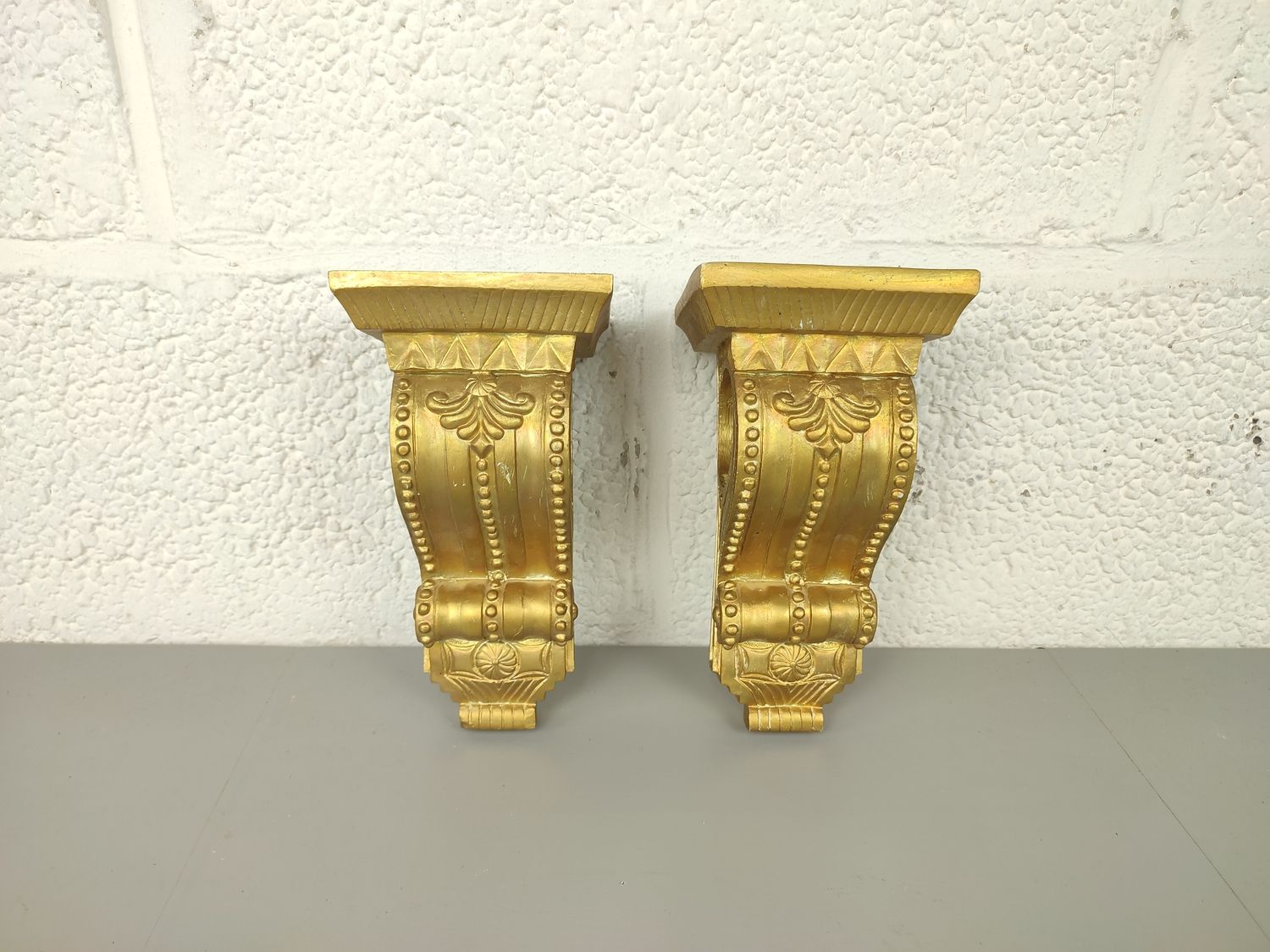 2 small gilded consoles