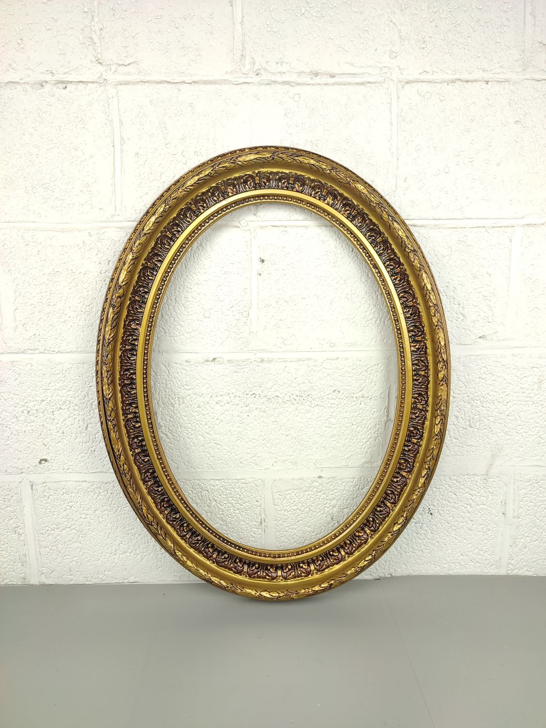 Gilded oval frame