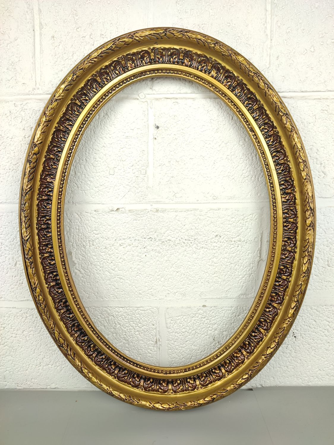 Gilded oval frame