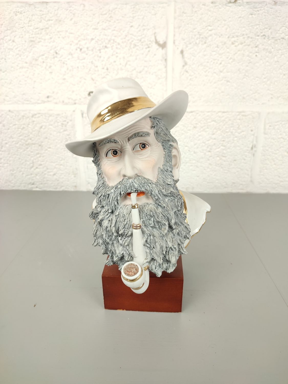 Porcelain sculpture of a pipe smoking man