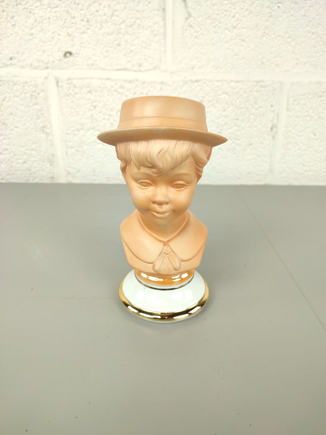 Porcelain bust of a boy with hat