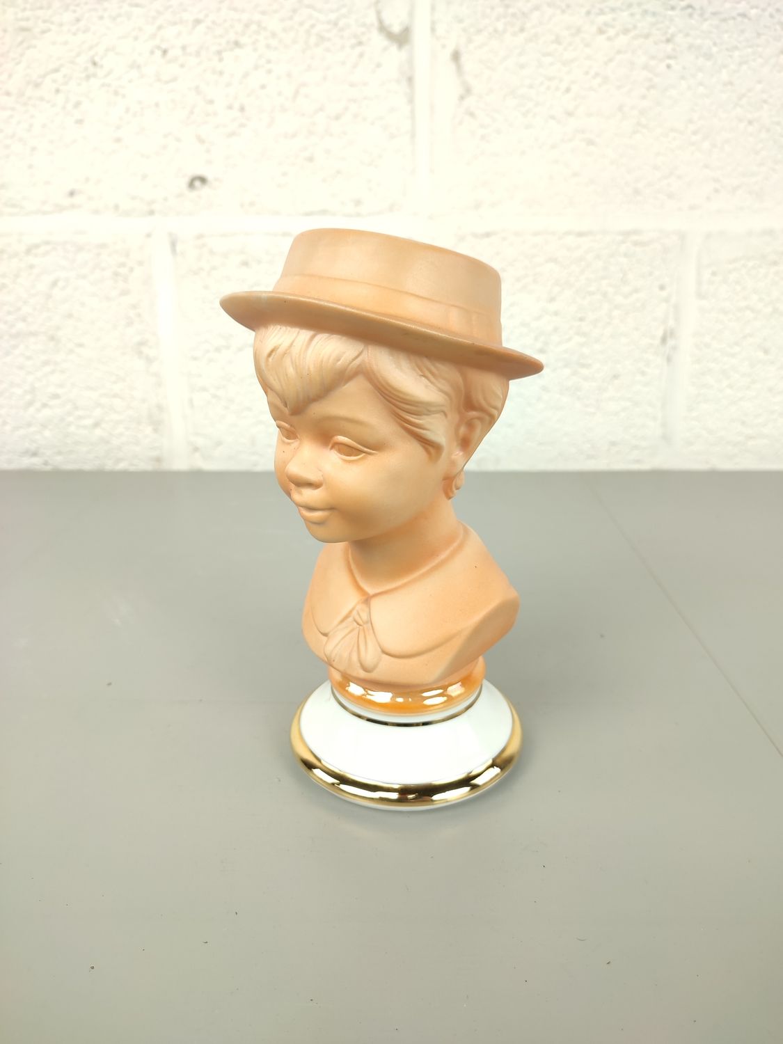 Porcelain bust of a boy with hat