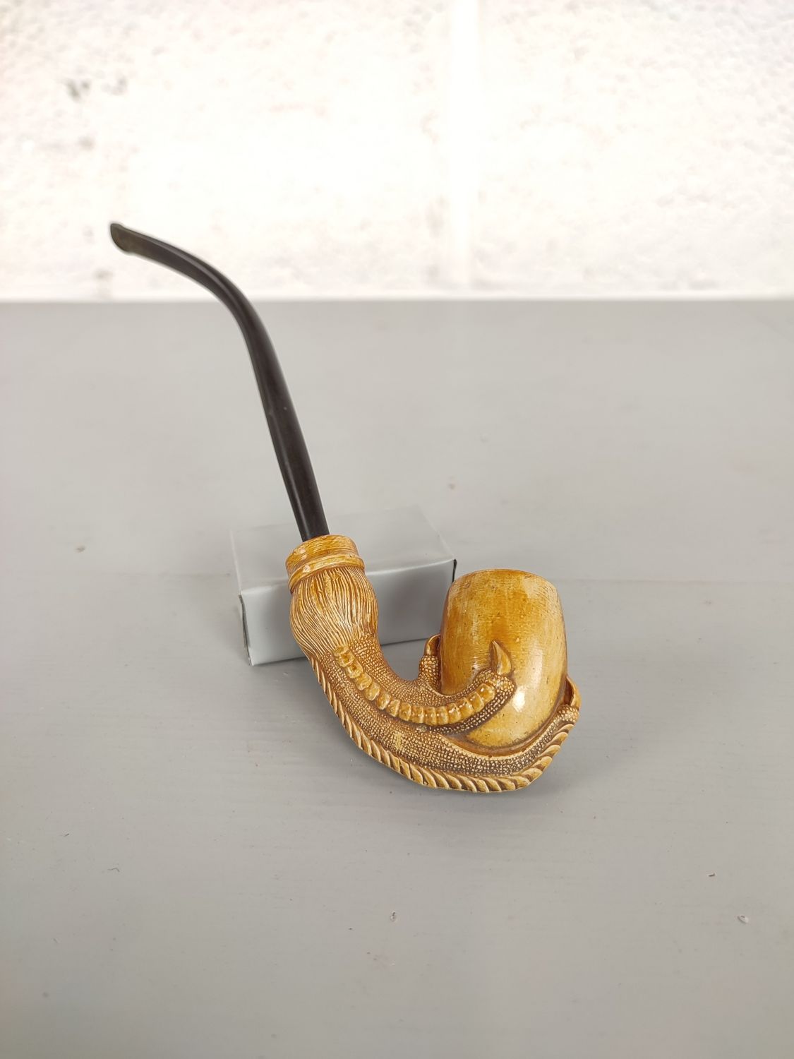 Antique clay pipe with bird&#39;s claw