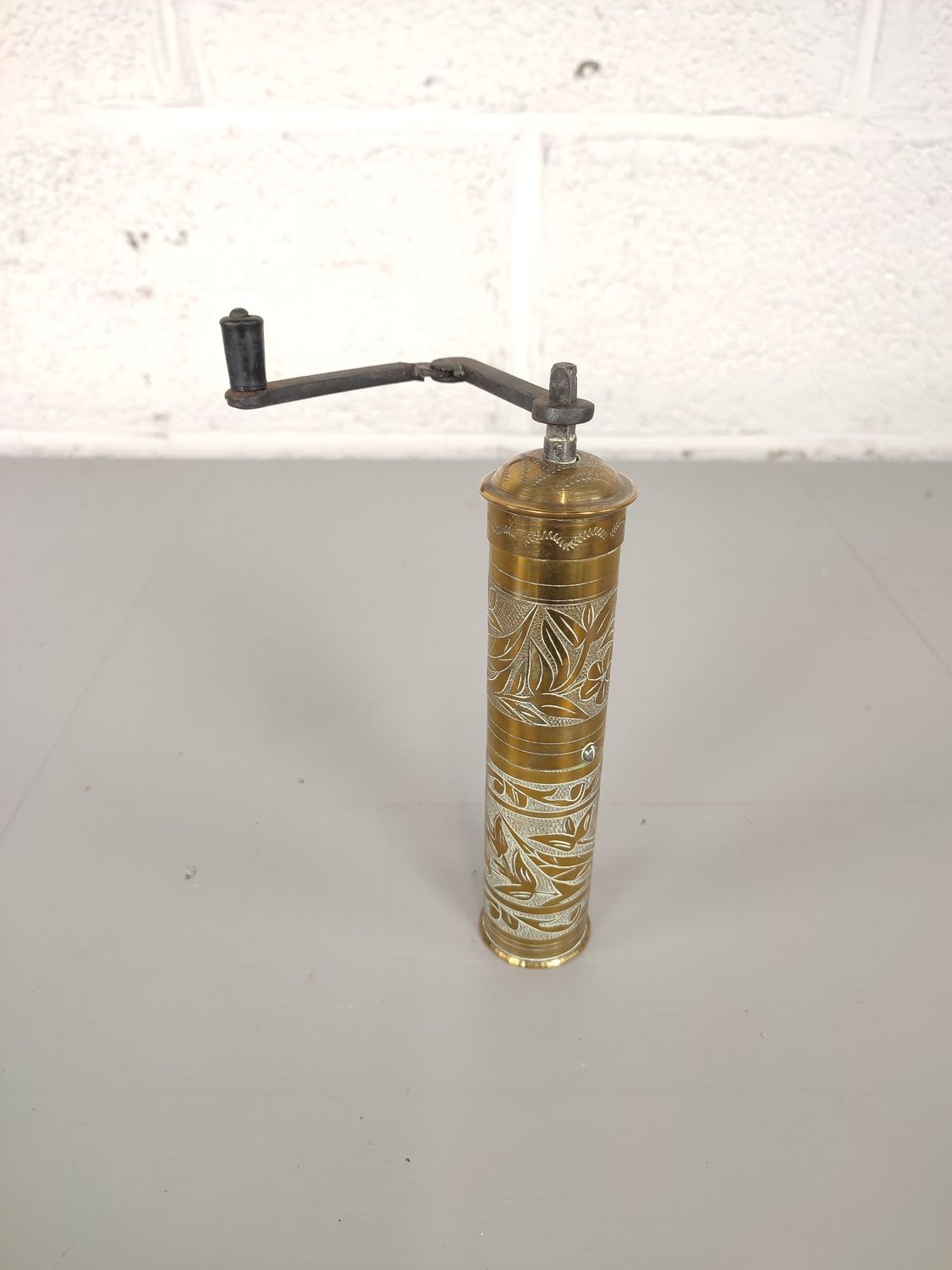 Oriental brass pepper mill
