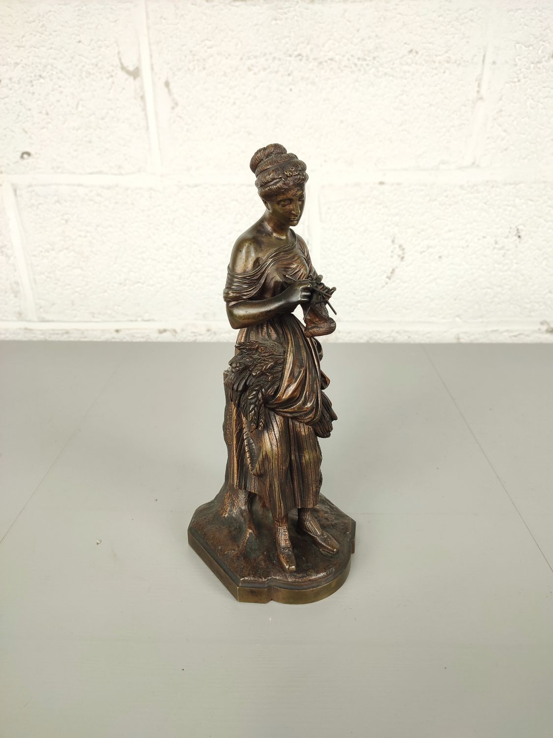 Bronze sculpture of lady knitting