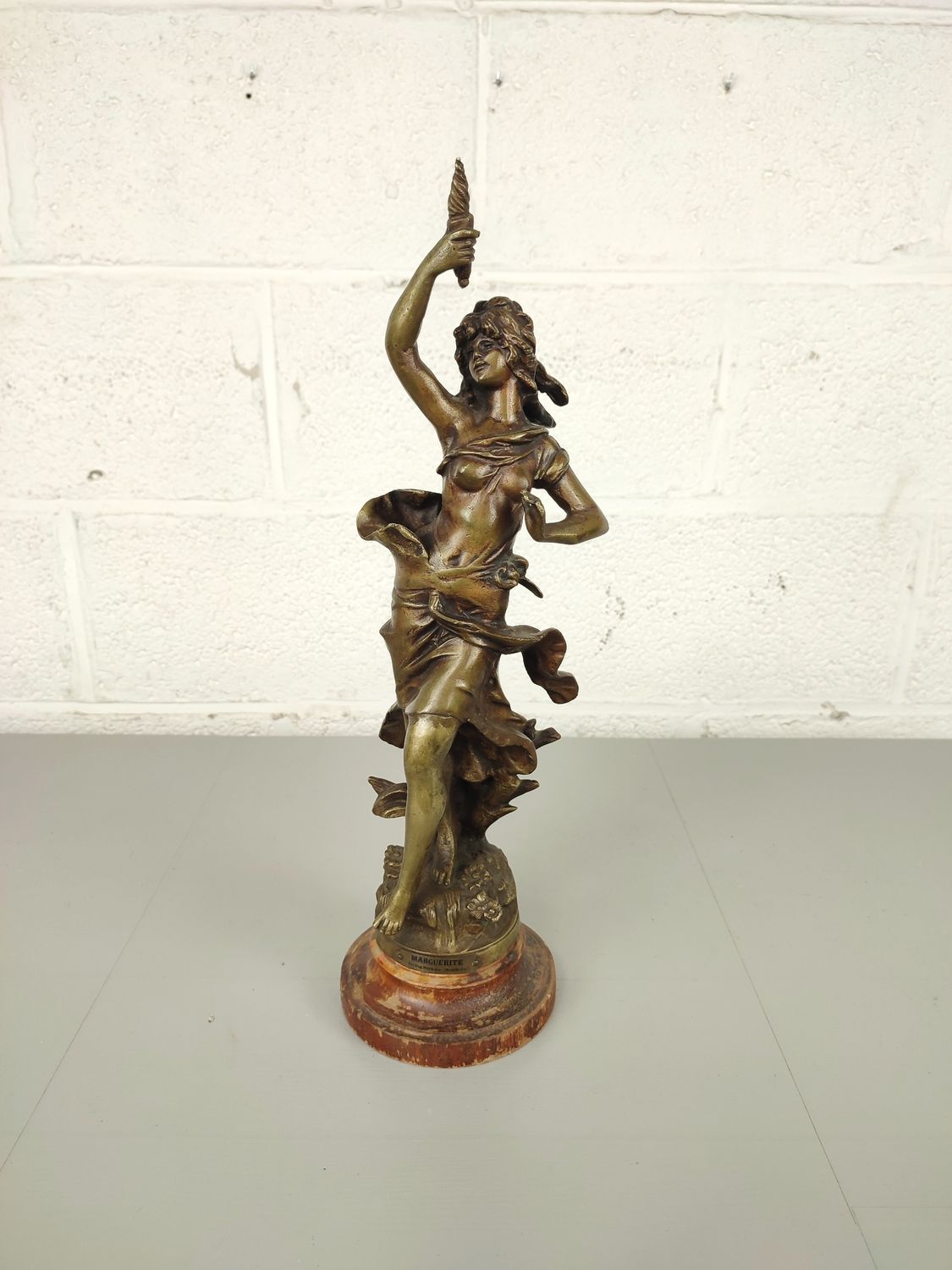 Bronze sculpture of a lady with torch
