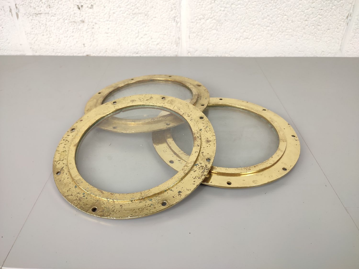 3 brass portholes of a ship