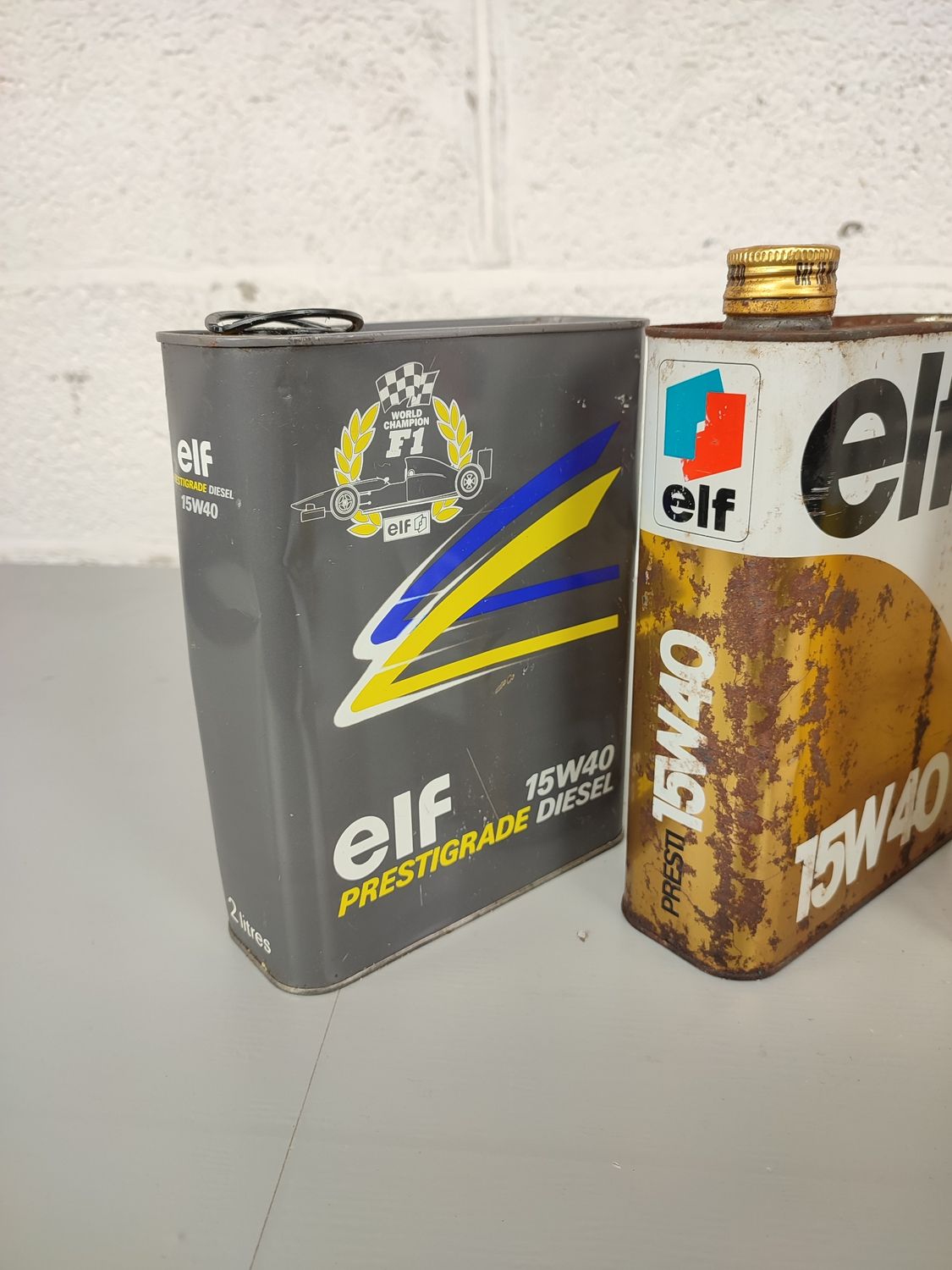 4 old Elf oil cans