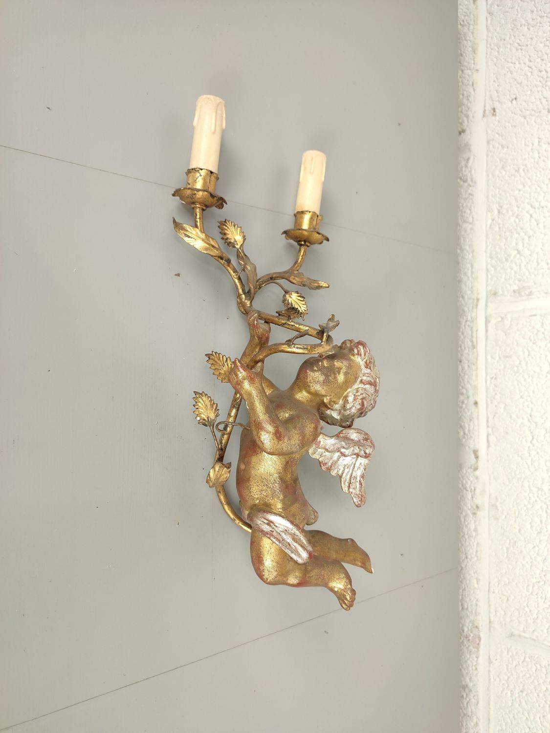 Antique wall light with cherub