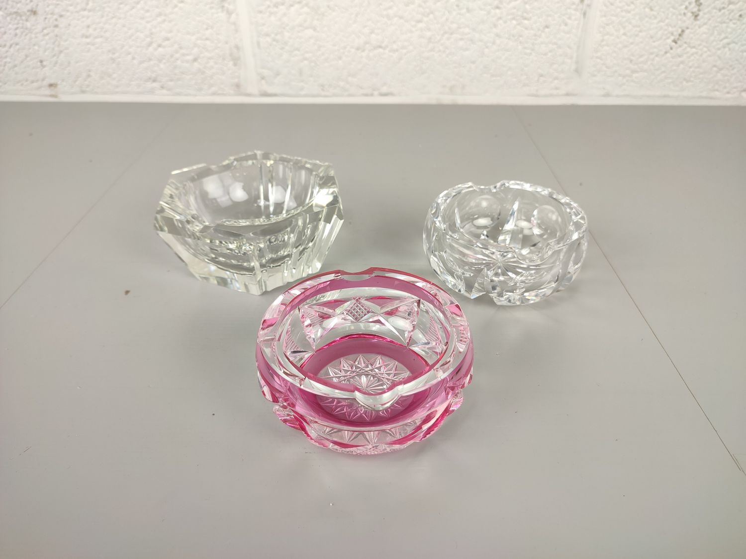 3 crystal ashtrays with chip