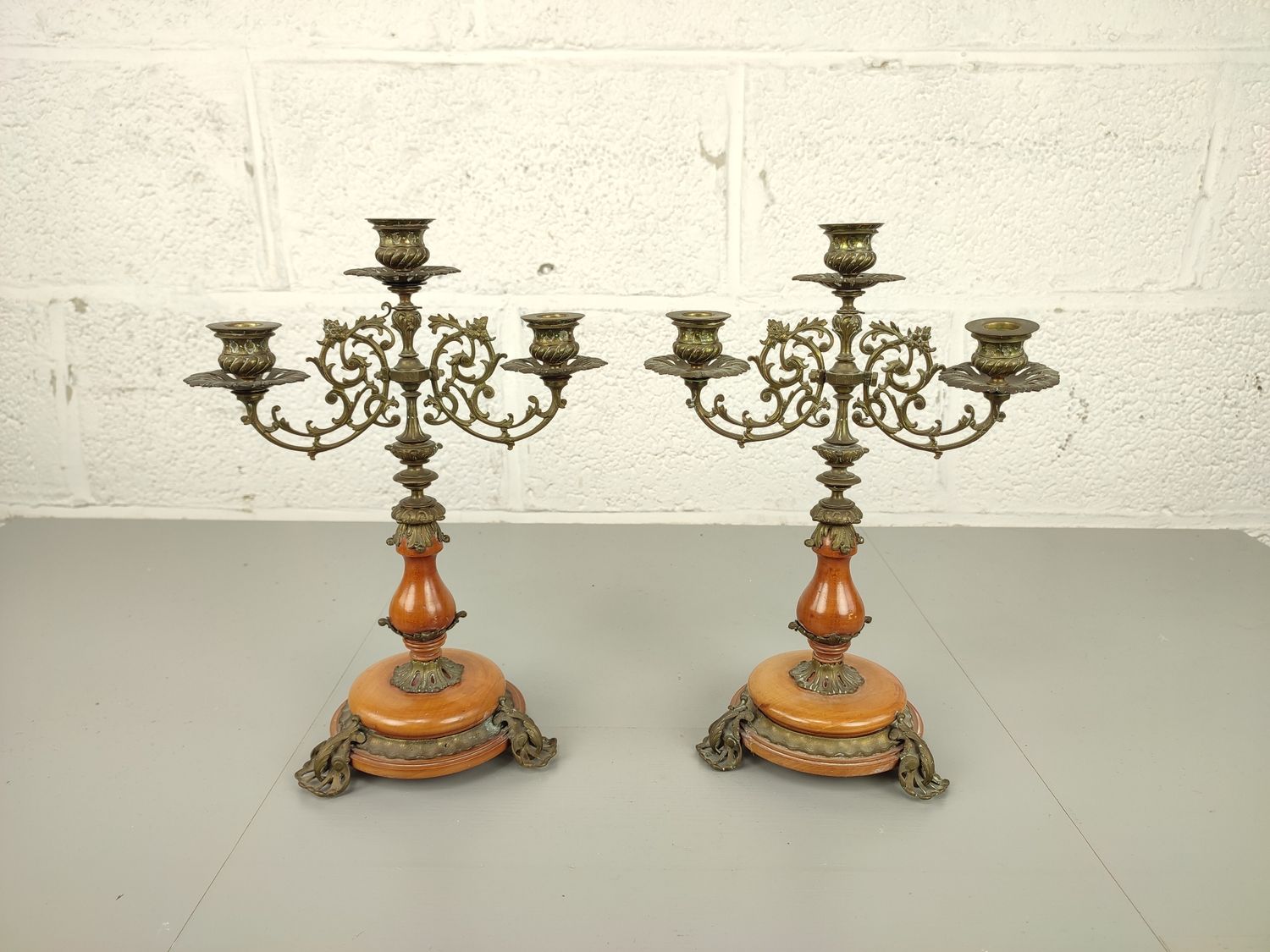 Pair of candelabras in brass and wood