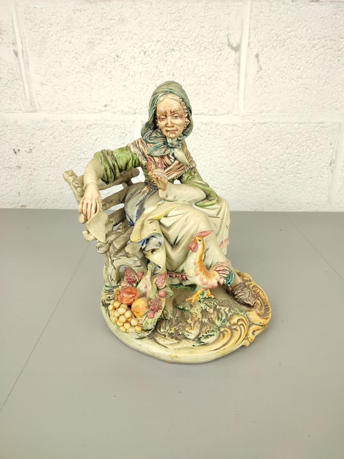 Biscuit statue of a lady on a bench
