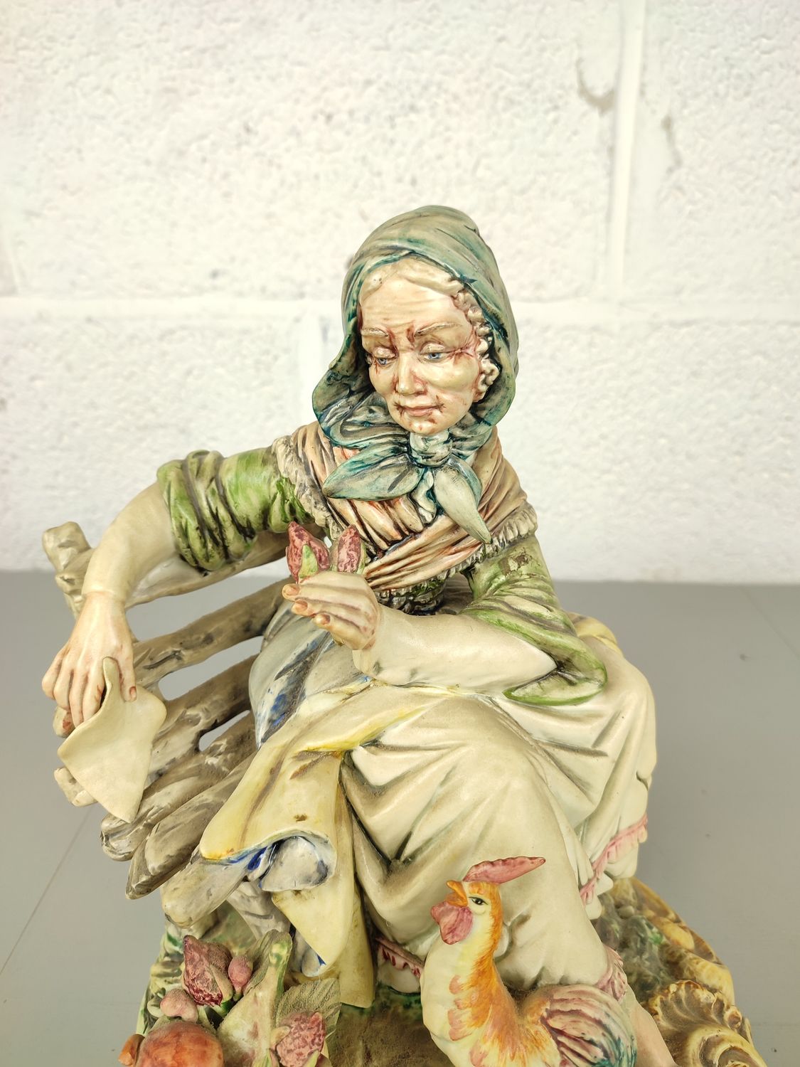 Biscuit statue of a lady on a bench