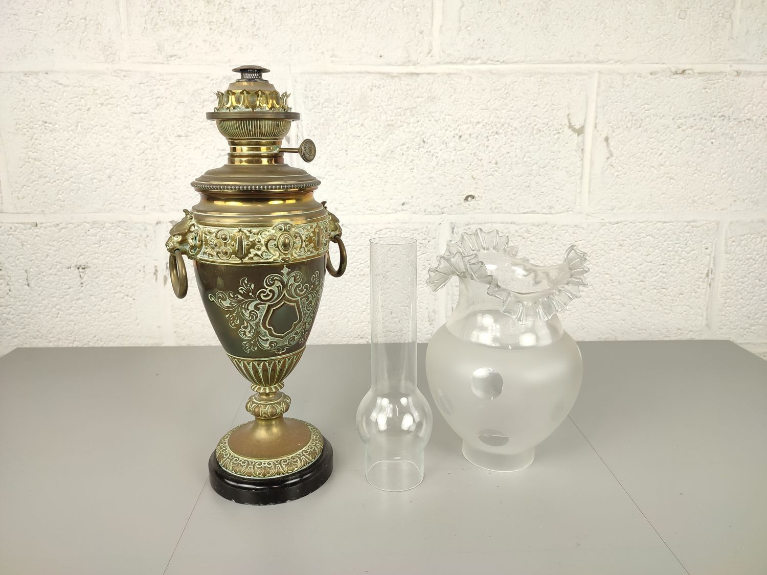Antique brass oil lamp on marble base