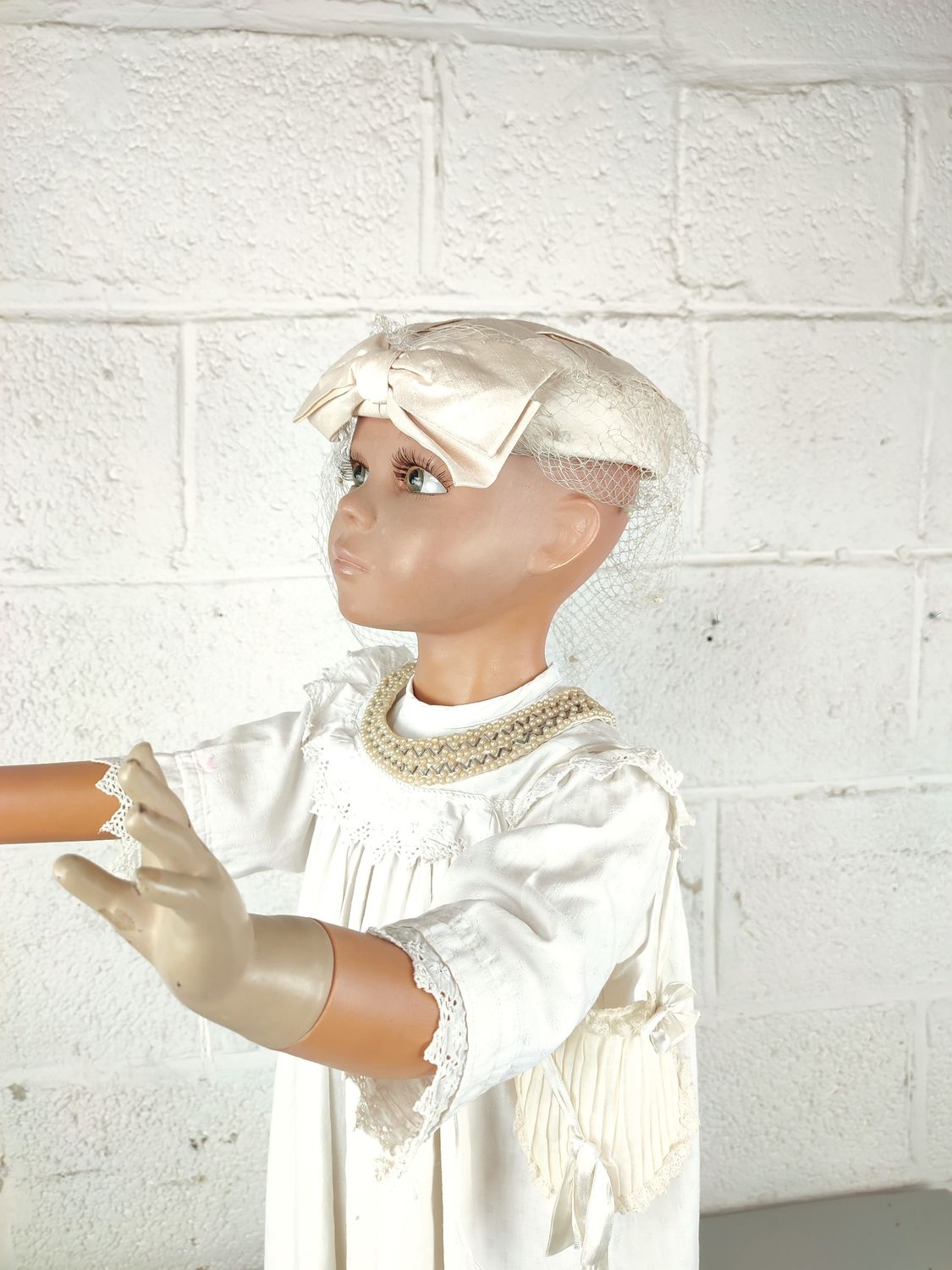 Child mannequin with christening dress