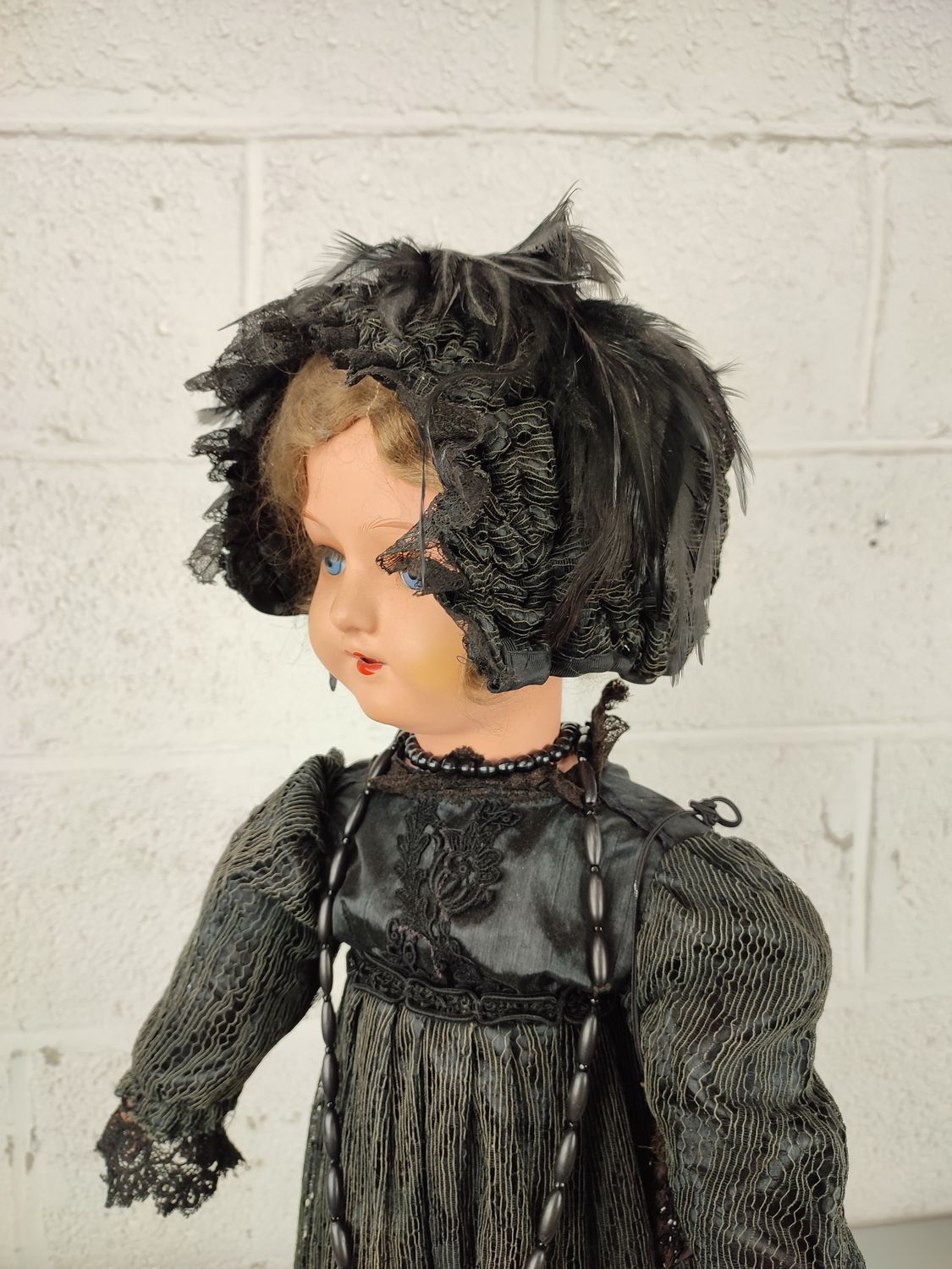 Old papier-maché doll with Victorian clothing