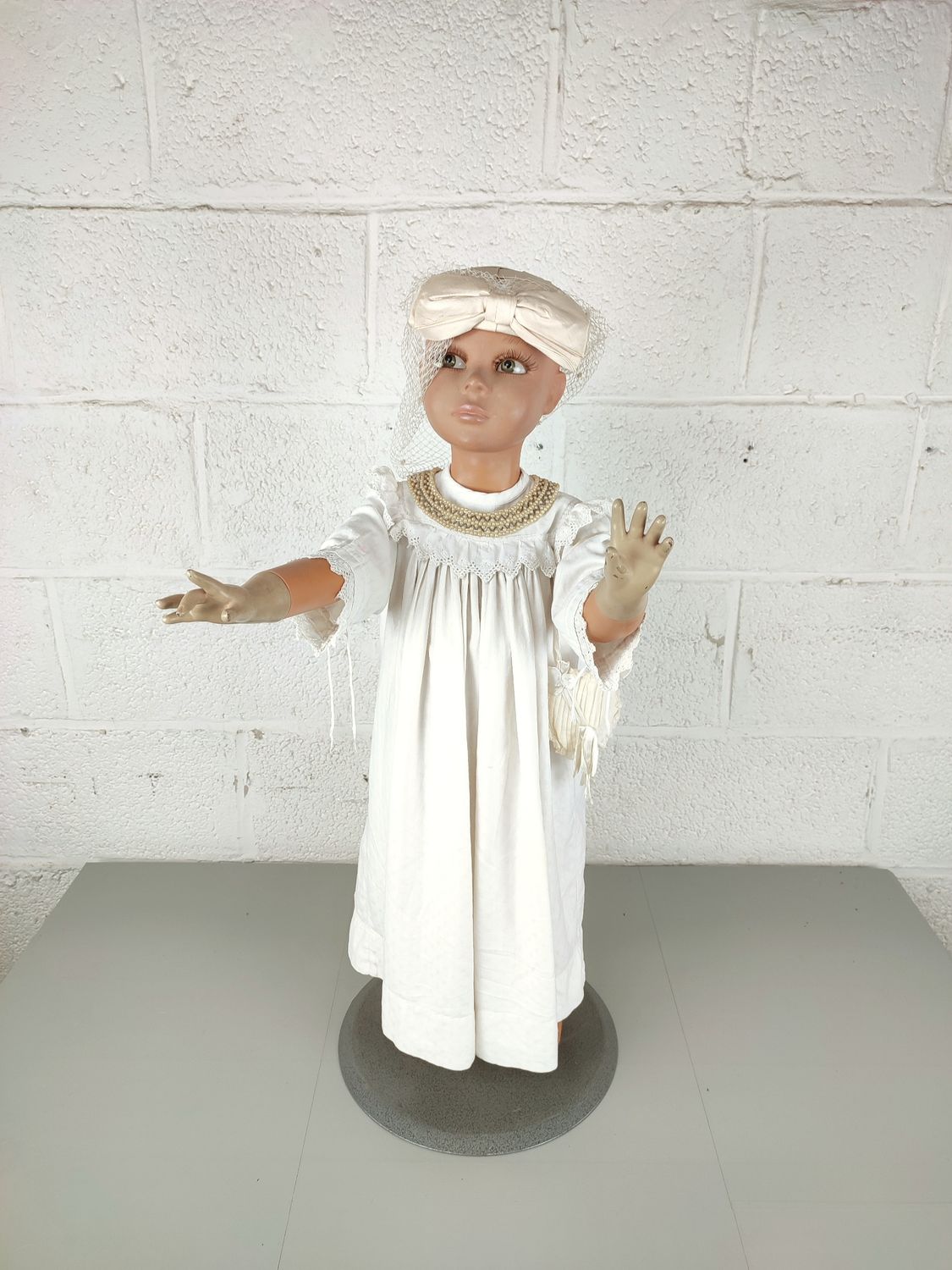 Child mannequin with christening dress