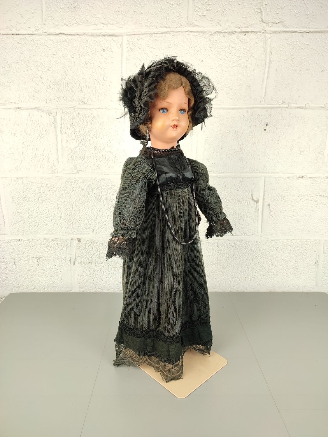 Old papier-maché doll with Victorian clothing