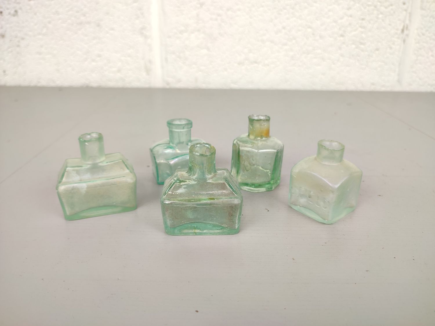 5 small glass ink bottles