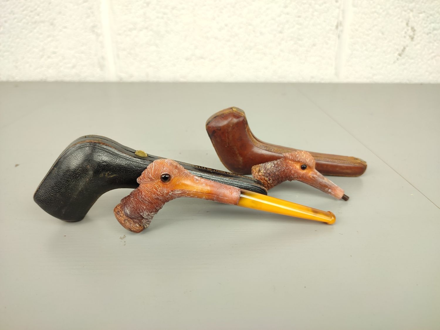Pair of old pipes with bird heads