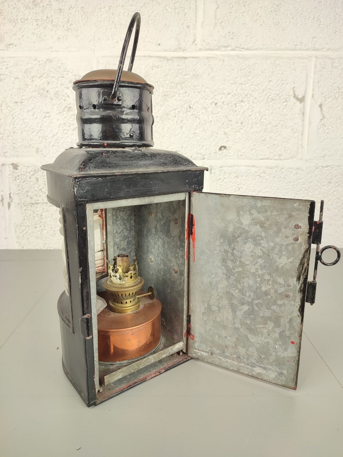 Old black-painted ship's lamp