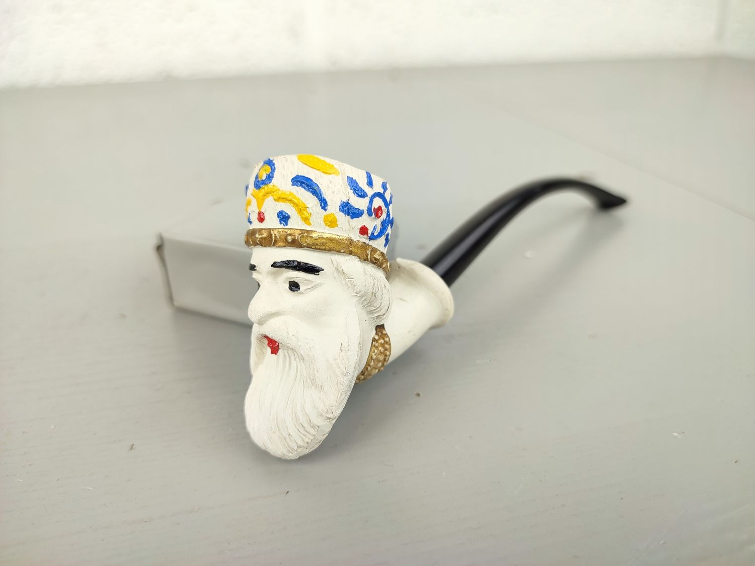 Old clay pipe with head