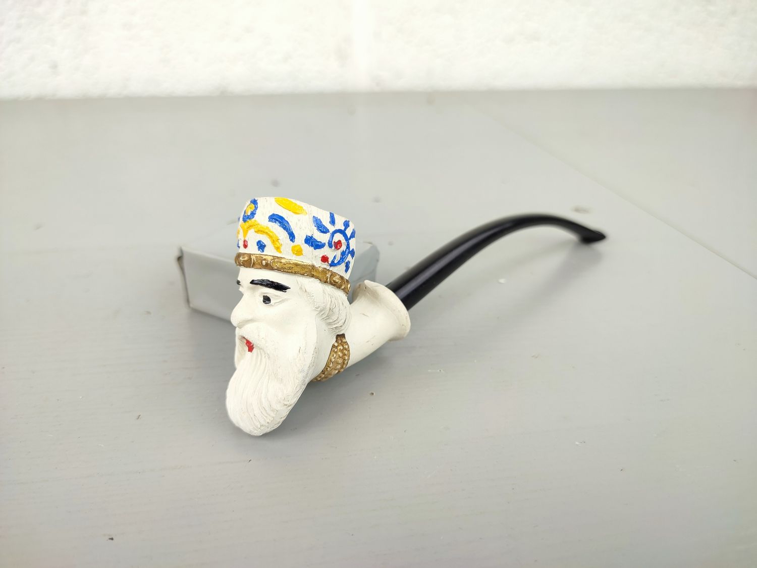 Old clay pipe with head