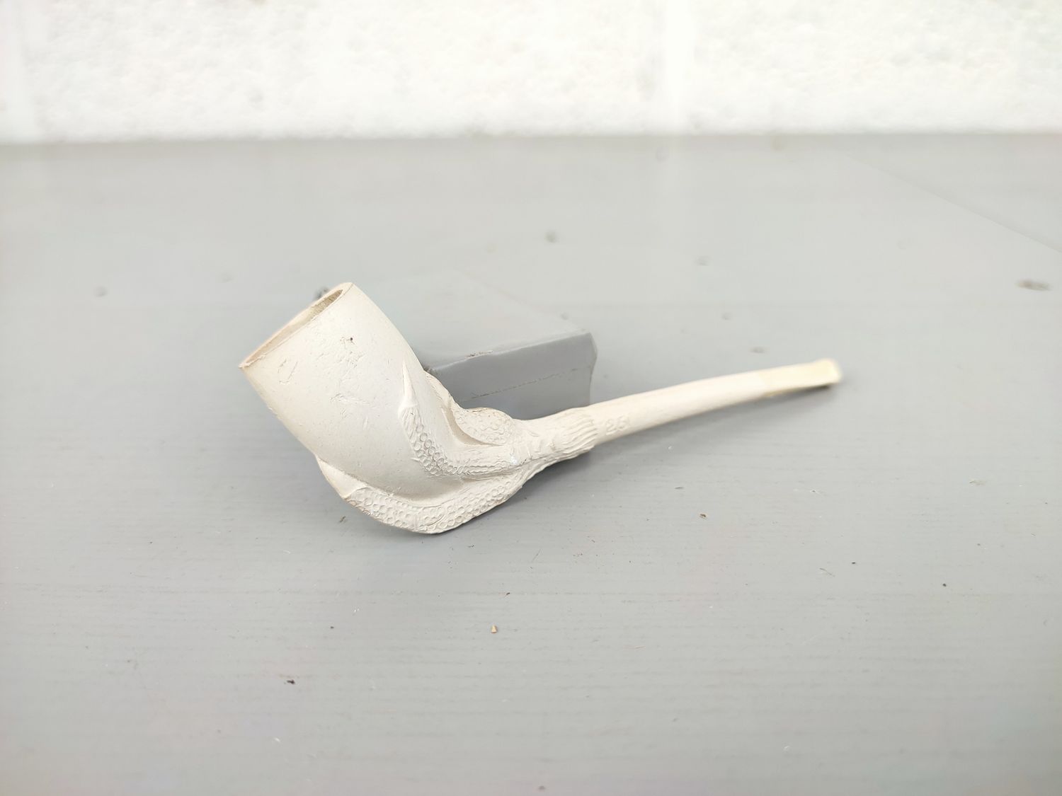 Old clay pipe with claw