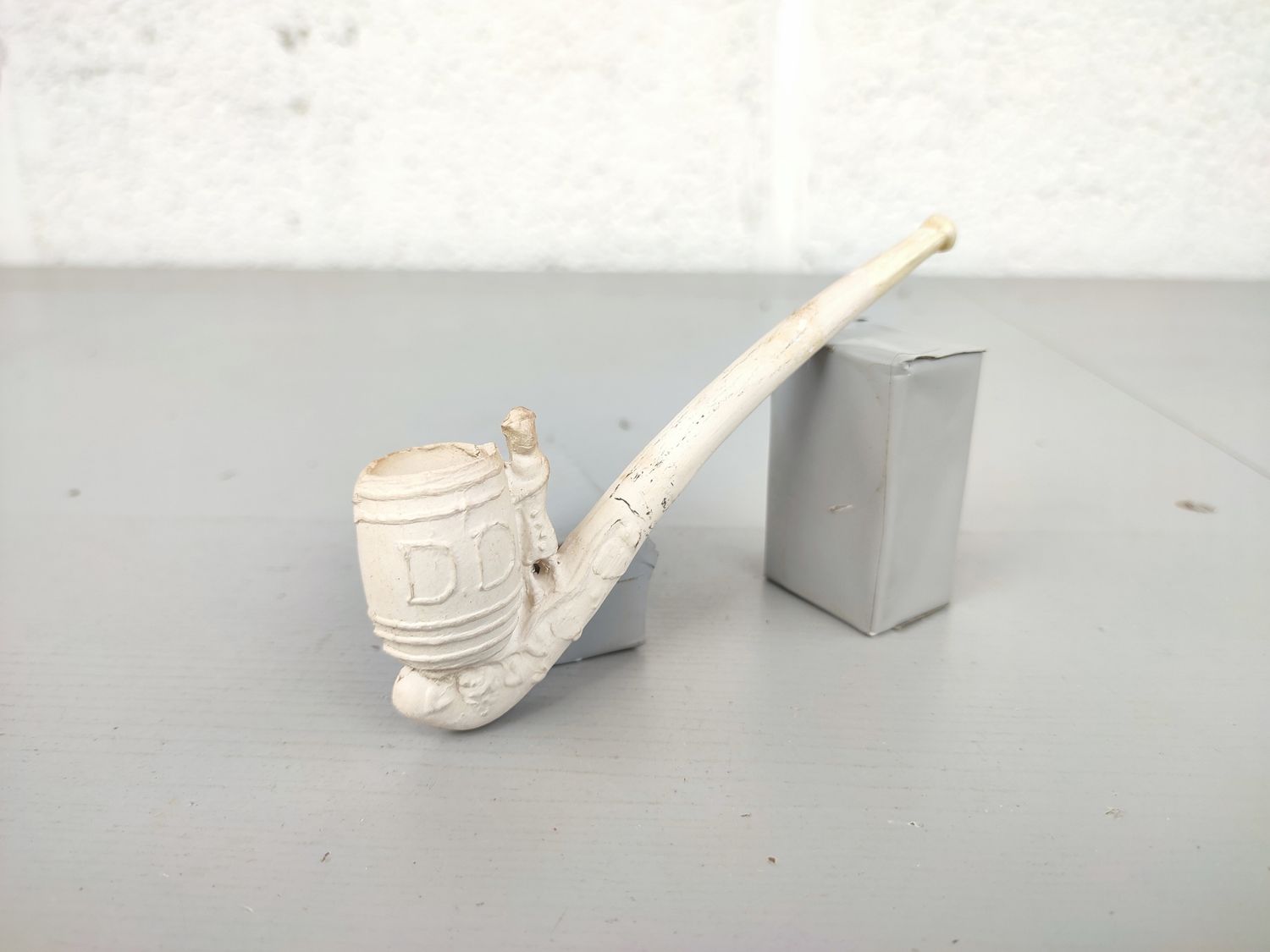 Old clay pipe with wine barrel venter