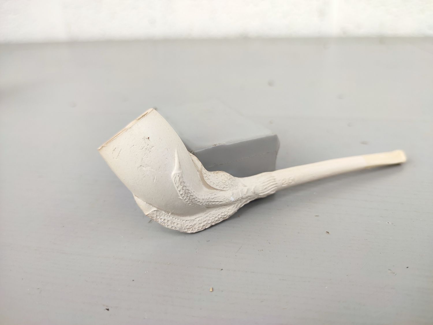 Old clay pipe with claw