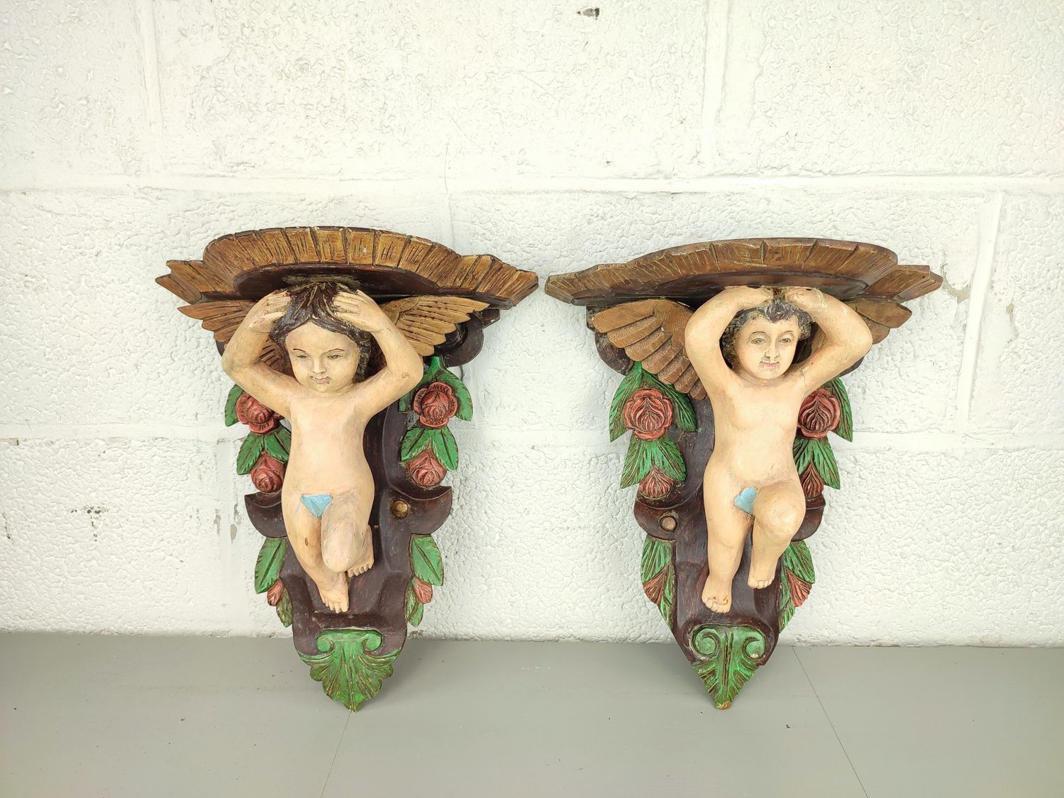 2 wooden wall ornaments with cherubs