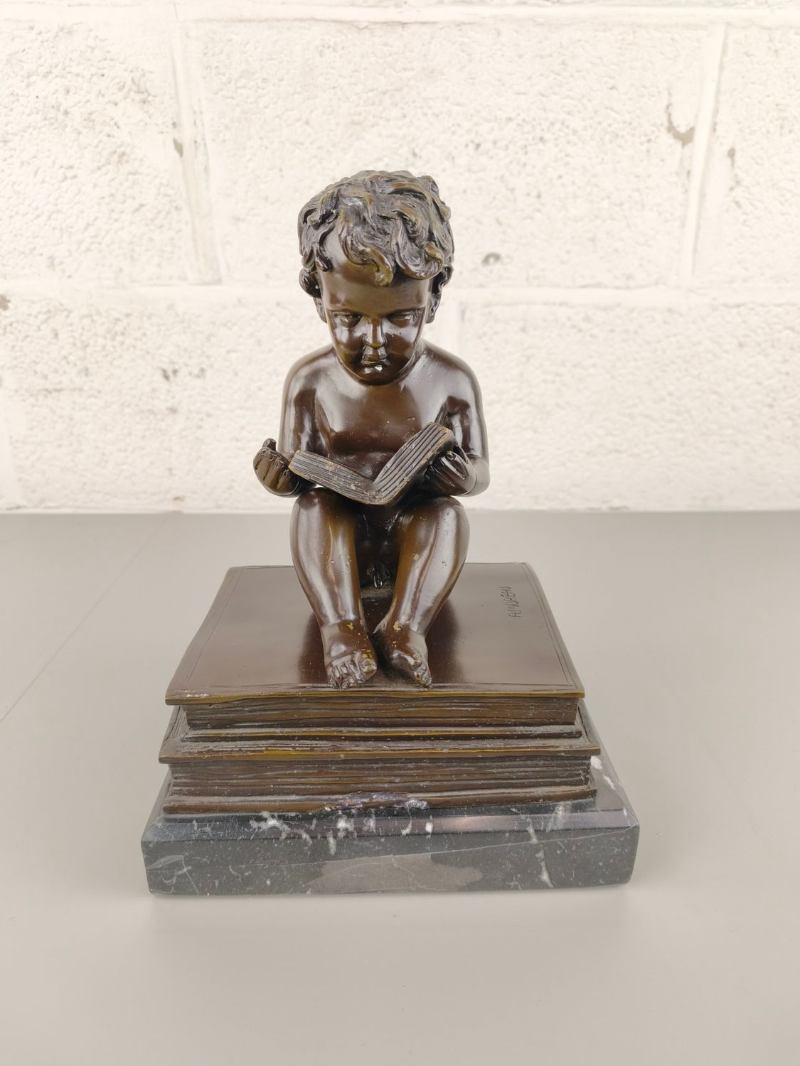 Bronze reading boy after A. Moreau