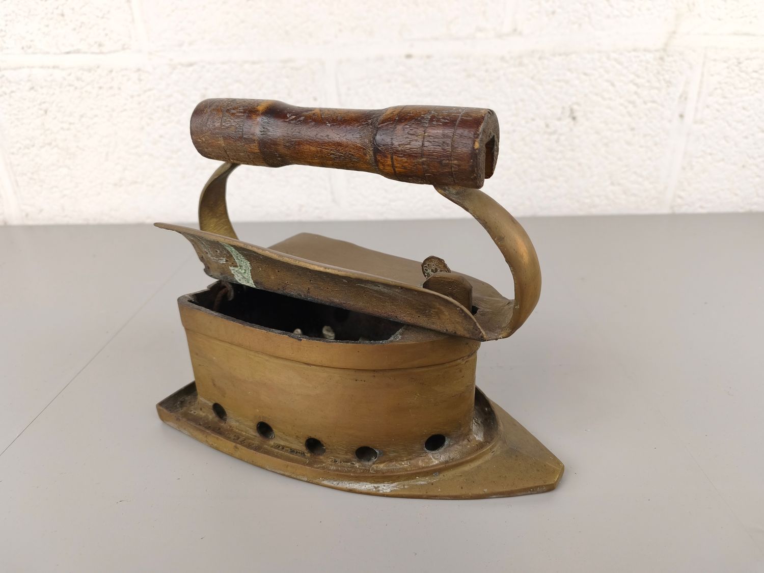 Large antique brass coal iron