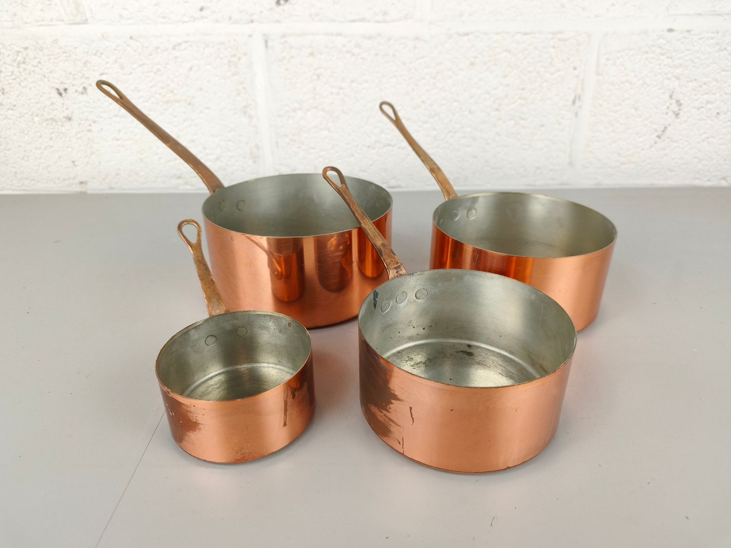 Set of copper saucepans