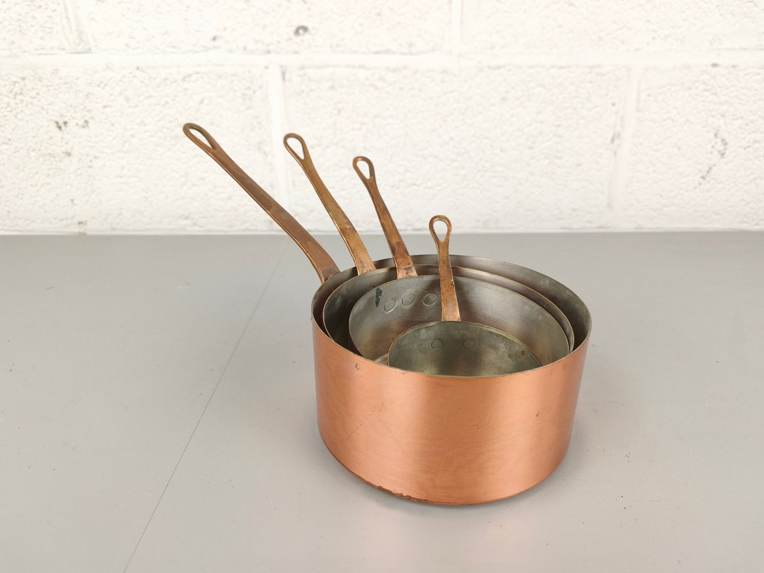 Set of copper saucepans