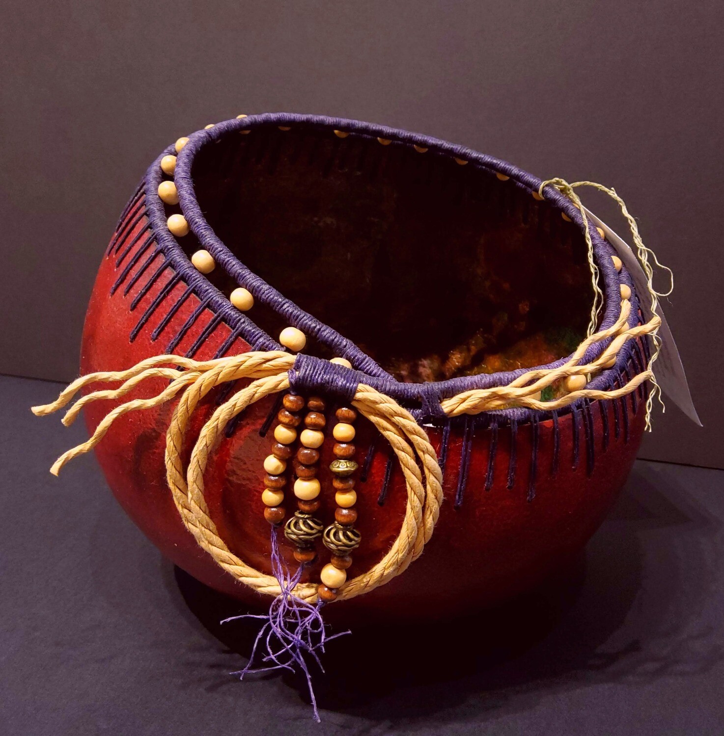 Cannonball gourd, red dyed and woven, By Larry Castleberry
