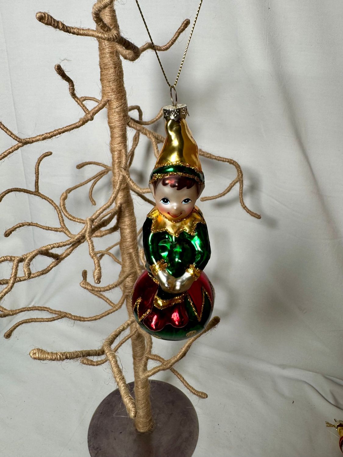 Glass Elf on Green Ball Ornament Glass Elf on Green Ball Ornament