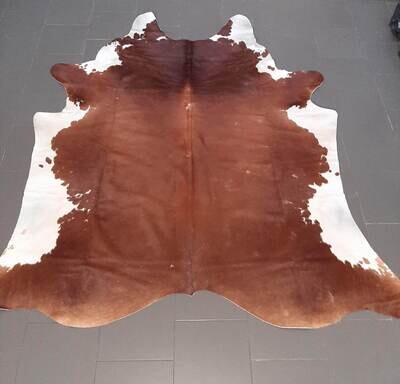 Cow leather with fur, brown and white color.