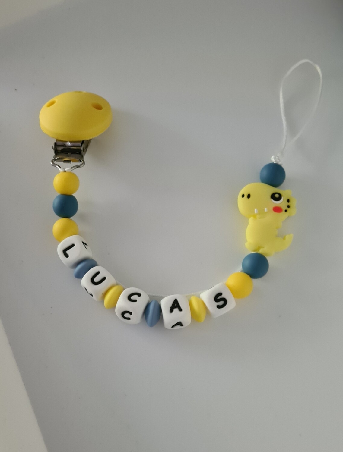 Attache tétine DINOSAURE jaune